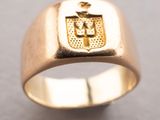 an image of a gold ring with a coat of arms