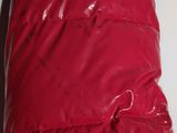a close up of a red puffer jacket with a zipper