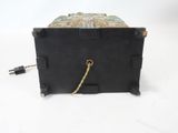 a small black box with a rope on top of it