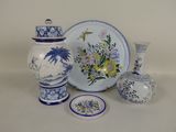 a lot of blue and white vases and plates on the table