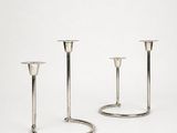 two silver candlesticks on a white background with a white background