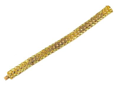 a close up of a gold bracelet on a white background