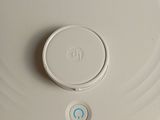 a white plate with a button on it sitting on a table