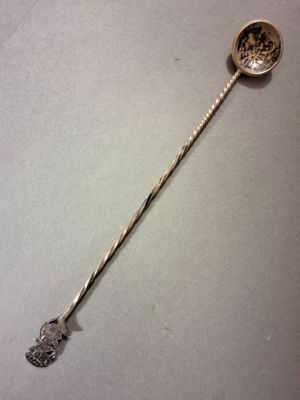 a silver spoon with a metal handle on a table
