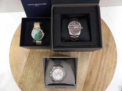 two watches and a watch box on a table