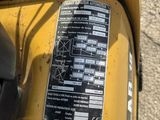 a close up of a yellow moped with a sticker on it