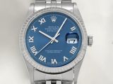 a close up of a wrist watch with roman numerals on it