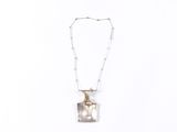 sterling silver necklace with mother and child in a glass box