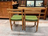 two chairs that are sitting in front of a table