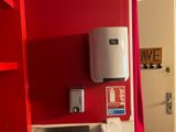 a picture of a red bathroom with a white toilet and a red shower curtain
