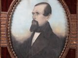 portrait of a man with a beard and mustache in a wooden frame