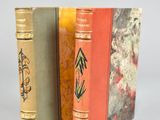 three books sitting next to each other on a table