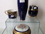 a glass shelf with a vase and other decorative items on it