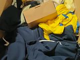 a cardboard box filled with clothes and other items
