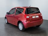 a picture of a small red car parked in a room