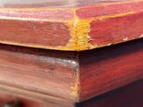a close up of a wooden table with a red top