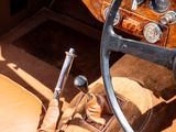 steering wheel and dashboard of a vintage car with a clock on it