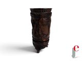 a wooden vase with carvings on it on a white surface