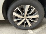 a close up of a tire on a car in a parking lot
