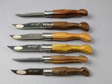 six different types of knifes are lined up on a table