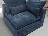 a blue couch with pillows on it in a room