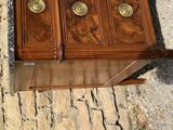a wooden chest with brass knobs on top of it