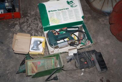 a box of tools sitting on the floor next to a box of wires