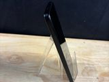 a cell phone that is sitting on a wooden table