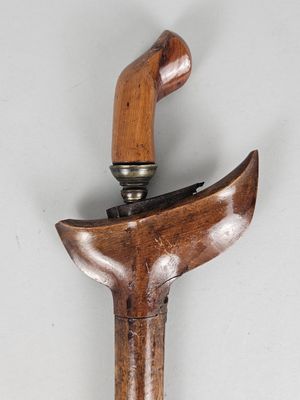 a close up of a cane with a wooden handle
