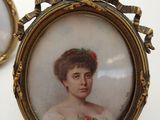 pair of miniature portraits of a woman with a rose in her hair