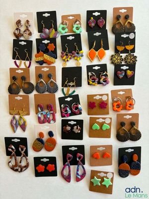 many pairs of earrings on display on the wall