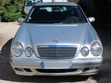 a silver car parked in the driveway of a house