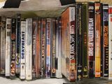 a lot of dvd ' s in a bag on the table