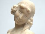 a statue of a woman that is sitting on a table