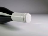 a bottle of wine sitting on a table with a white background