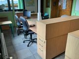 a desk with two chairs and a computer on it