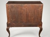 an old wooden chest with a drawer on top of it