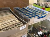 a lot of records in a box on the shelf