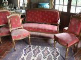 four chairs and a couch in a room with a rug on the floor