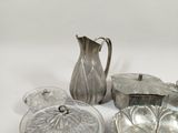 several pieces of silverware sitting on top of a white table