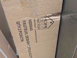 a cardboard box sitting on top of a pile of boxes