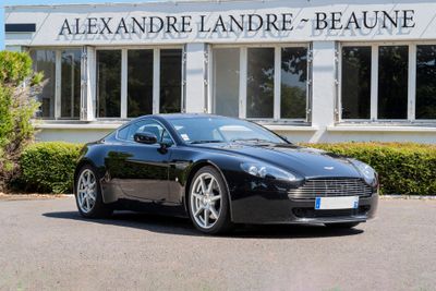 the black sports car is parked in front of the building