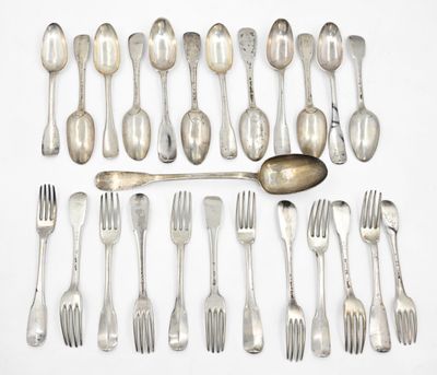 a lot of spoons and forks laid out on a table