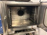a metal oven with a door open in a kitchen