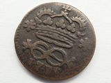 an old coin with a crown on top of it on a white surface