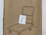 cardboard box with a cart dolly on it sitting on a floor
