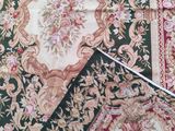 a close up of a pile of rugs with different colors and patterns