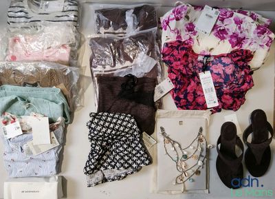 beaucoup de vêtements et de chaussures posés sur une table