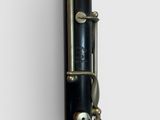 a close up of a clarinet with a black body and gold hardware