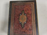 a small wooden box with a decorative design on it